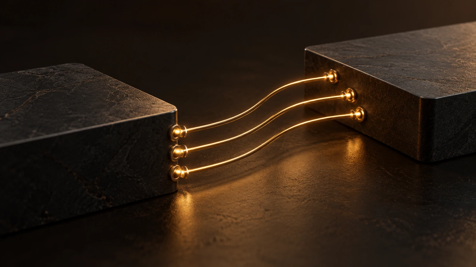 Two stone blocks joined by three gold cables
